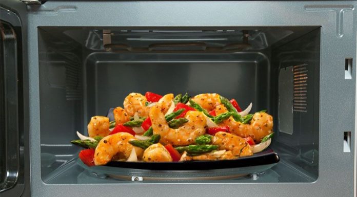 What happens if you stand near a working microwave? Why?