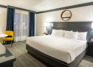 Why do hotels typically use white-colored sheets, blankets, and pillows?