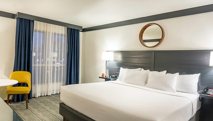 Why do hotels typically use white-colored sheets, blankets, and pillows?