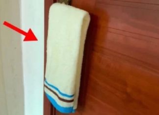 Why should you hang a wet towel on the door handle in a hotel?