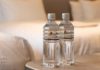 Why should you throw a bottle of water under the bed after checking into a hotel room?