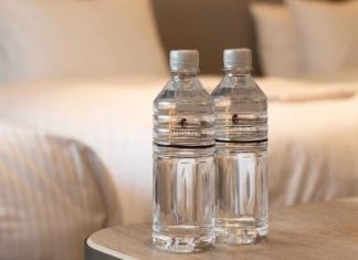 Why should you throw a bottle of water under the bed after checking into a hotel room?