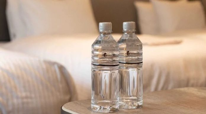 Why should you throw a bottle of water under the bed after checking into a hotel room?