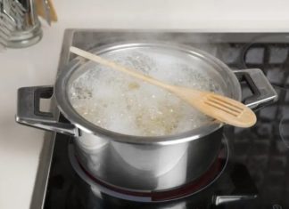 What is the purpose of placing a wooden spoon over a boiling pot?
