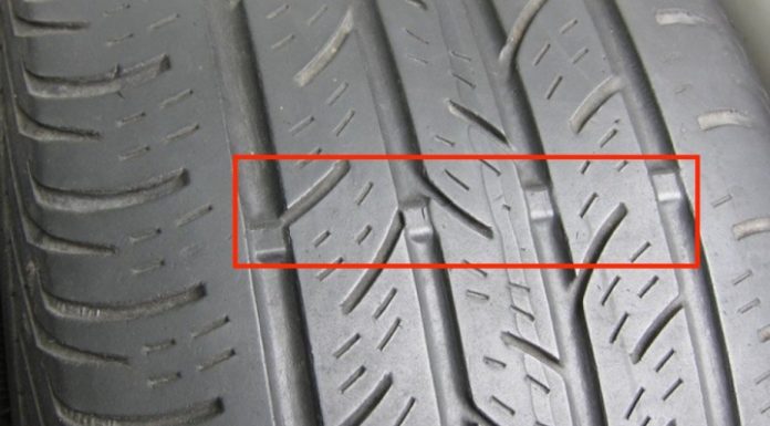 What is the meaning of the triangle symbol on a car tire?