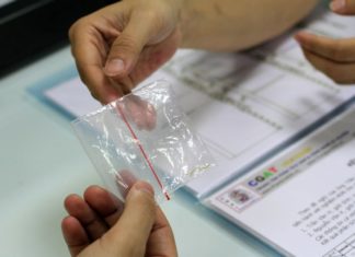 A 3-generation curly haired house, with a straight-haired child, the father silently undergoes DNA testing.