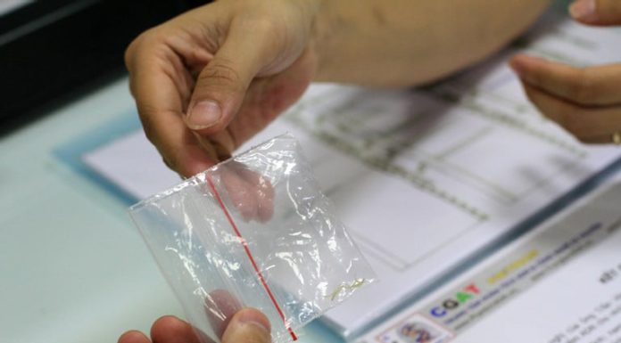 A 3-generation curly haired house, with a straight-haired child, the father silently undergoes DNA testing.