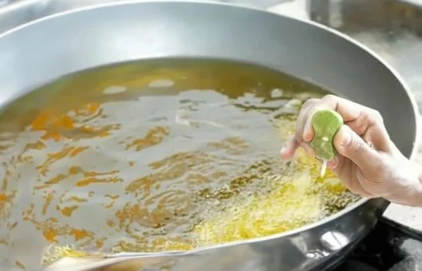 What’s the use of squeezing lemon into the frying pan while deep frying?