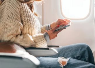 Why should you wear loose-fitting jeans on an airplane?