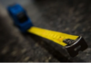 What is the Purpose of the Hole and the Serrated Edge on the End of a Measuring Tape?