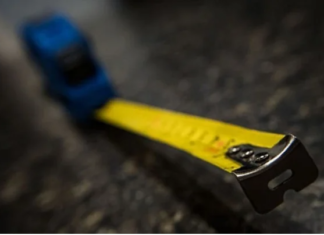 What is the Purpose of the Hole and the Serrated Edge on the End of a Measuring Tape?