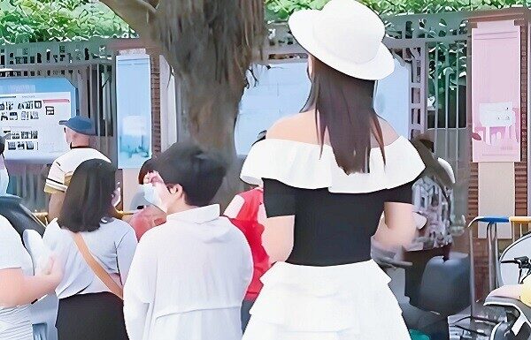 The Mom in a Mini Skirt Picking Up Her Child: Embracing Two Stylish Approaches That Make Moms the Apple of Their Children’s Eyes.